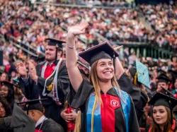 Graduate waving to her family